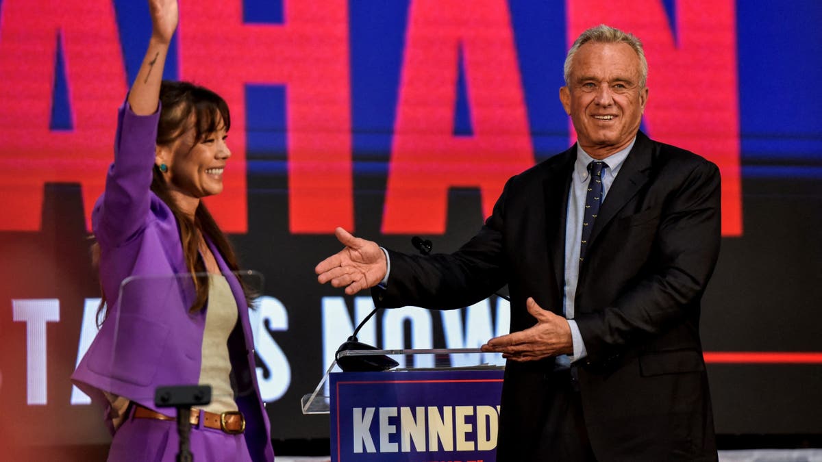 Robert F. Kennedy, Jr. gestures next to Nicole Shanahan